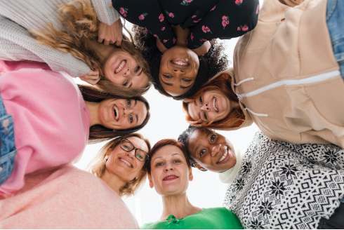 image of a group of girlfriends huddled together in a big circle, symbolizing friendship, unity, and the strong bond between women. The power of female friendships
